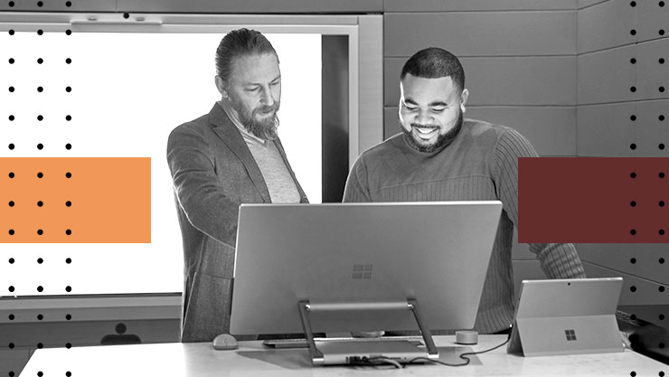 Stylized image of two men looking at a large computer monitor