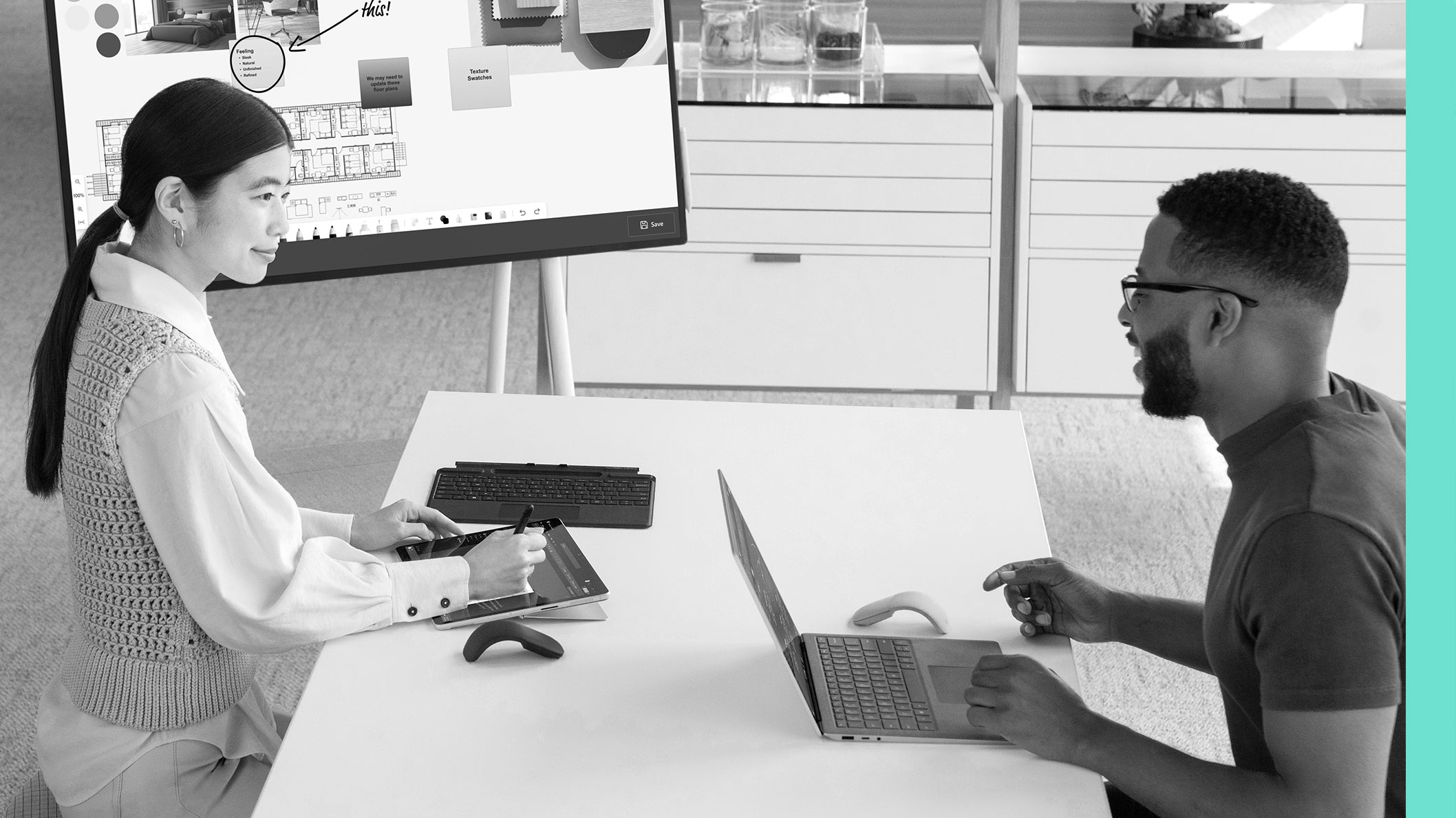 Two colleagues having a discussion at a desk