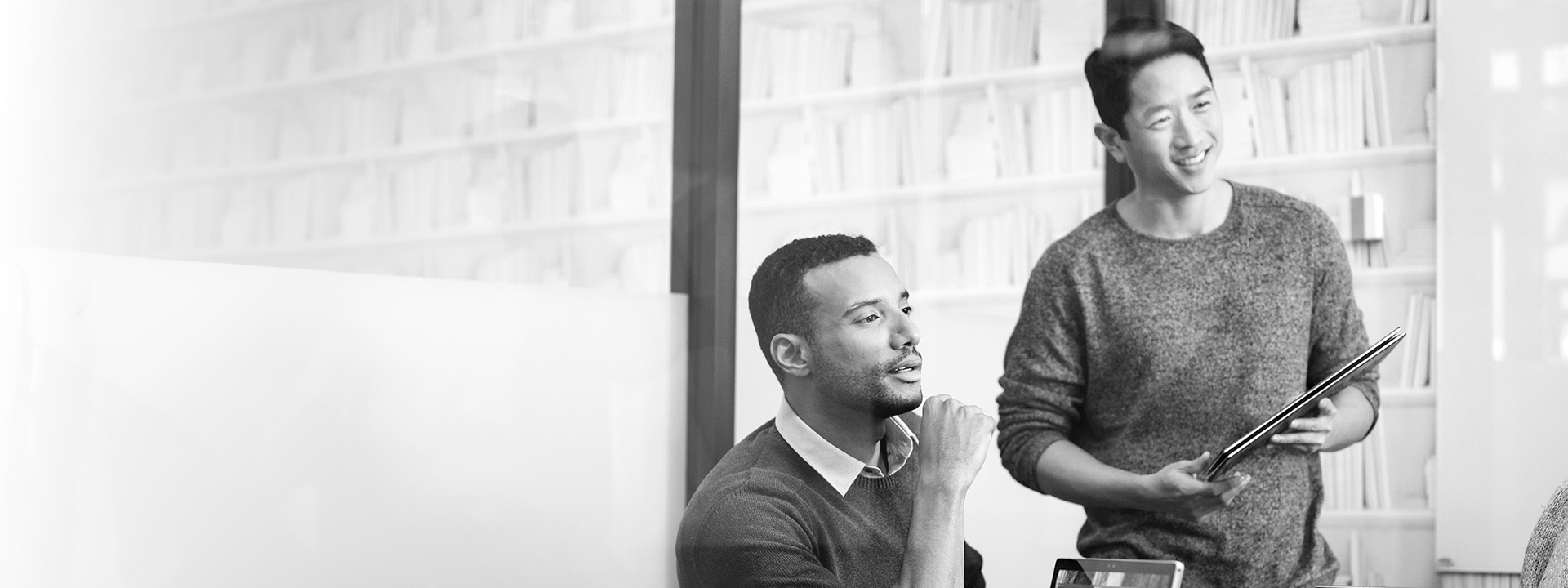 Two coworkers collaborating at a conference table