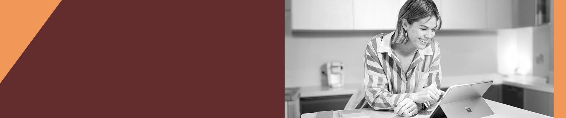 A woman leaning on her counter using her tablet