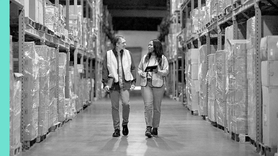 Two people having a conversation in a warehouse