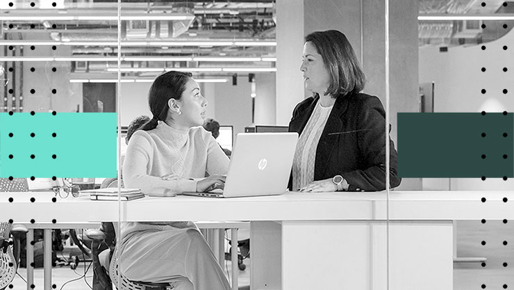 Two women having a conversation in an office