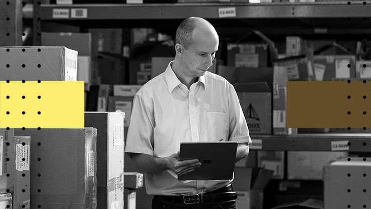 A man using a tablet in a warehouse