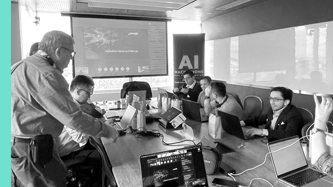 A group of people in a conference room engaged in a meeting with a screen displaying a presentation about AI