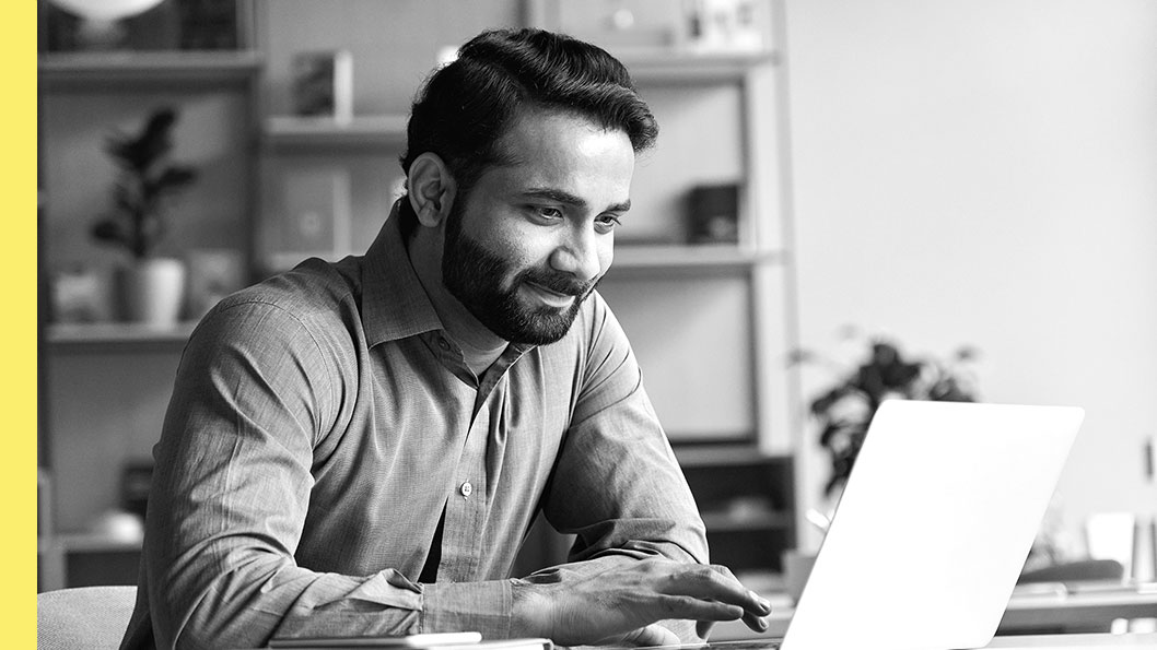 A man looking at his laptop